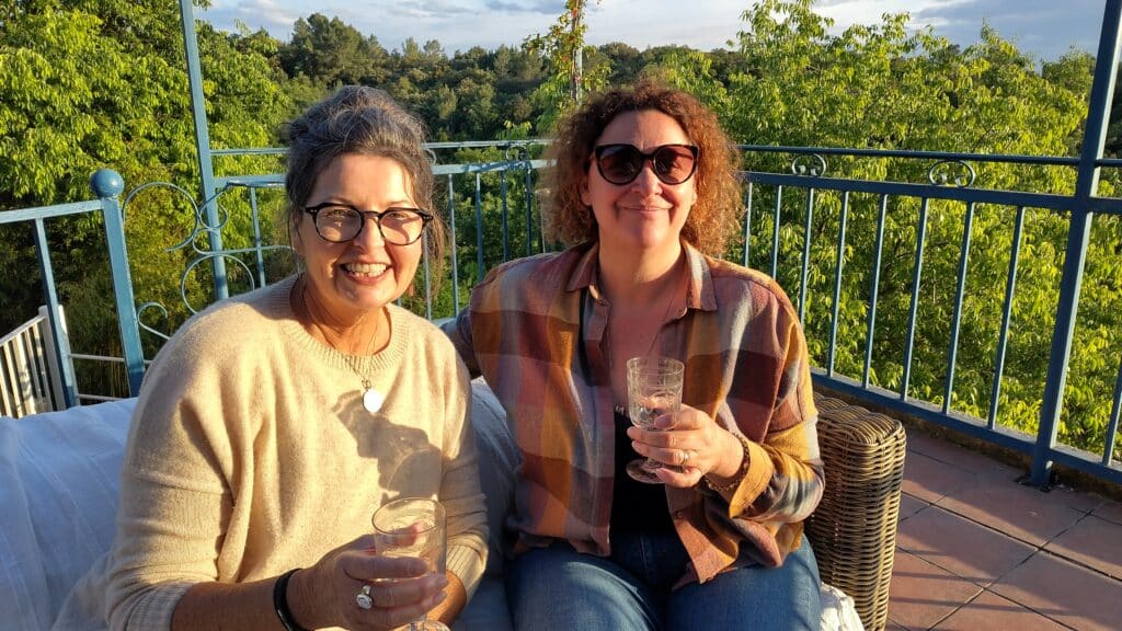 French teacher Gwen sharing a drink with her student on her terrace after a day out
