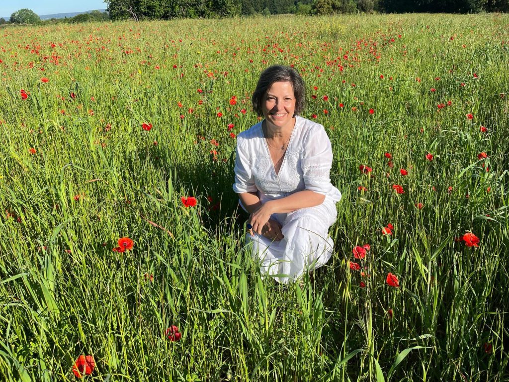 Student sitting in a poppy field in Provence